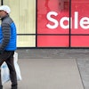 A shopper passes a clothing store in the Thornton Premium Outlets, Thornton, Colo., Dec. 18, 2023.