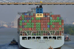 The container ship COSCO Development is guided under the Talmadge Bridge in Savannah, Ga., May 11, 2017.