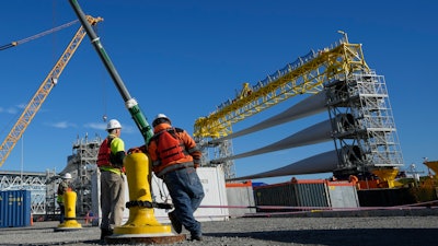 A generator and its blades are prepared for the South Fork Wind farm, State Pier, New London, Conn., Dec. 4, 2023.