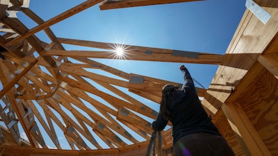 Workers build a home in Marshall, N.C., Sept. 19, 2023.
