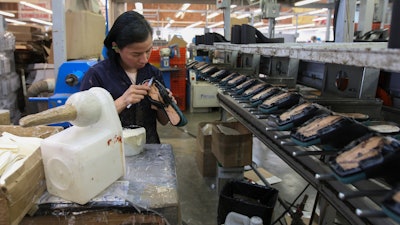 A woman works in a shoe factory, Leon, Mexico, Feb. 7, 2023.