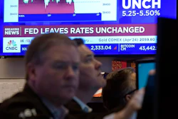 A television screen on the floor of the New York Stock Exchange displays the Federal Reserve's decision on interest rates, Jan. 31, 2024.