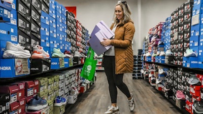 Ashley Crafton looks at tennis shoes at Shoe Stop in Wesleyan Park Plaza, Owensboro, Ky., Nov. 25, 2023.