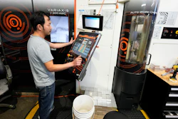A worker at Reata Engineering and Machine Works programs a Mazak Variaxis machine used to make semiconductor pieces, Feb. 15, 2024, Englewood, Colo.