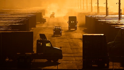 Workers drive among shipping containers and trailers at a BNSF intermodal terminal, Edgerton, Kan., Jan. 3, 2024.