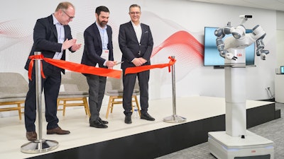 From left, ABB's Marc Segura, John Bubnikovich and Sami Atiya cut the ribbon on ABB Robotics' renovated facility, Auburn Hills, Mich., March 13, 2024.