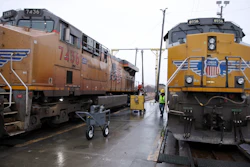 A Union Pacific worker walks between two locomotives, Council Bluffs, Iowa, Dec. 15, 2023.