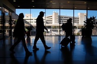 Travelers walk through Philadelphia International Airport, Feb. 16, 2024.