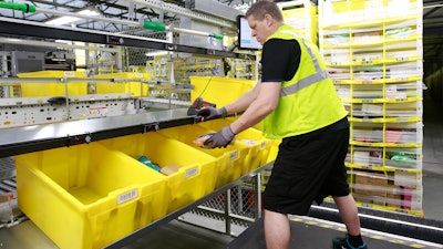 Merchandise is scanned to be tracked as it moves through the new Amazon Fulfillment Center in Sacramento, Calif., on Feb. 9, 2018.