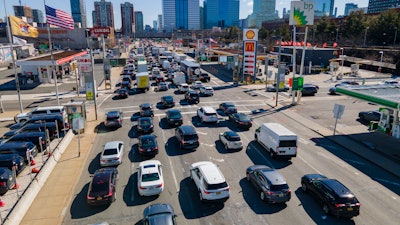 Commuters wait to drive through the Holland Tunnel into New York City, Jersey City, N.J., March 8, 2023.