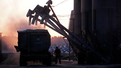 A feed truck is loaded at the Flood Brothers Farm, Clinton, Maine, April 1, 2024.