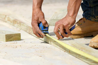 A beam is measured and marked at a housing site in Madison County, Miss., March 16, 2021.