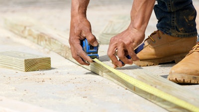 A beam is measured and marked at a housing site in Madison County, Miss., March 16, 2021.