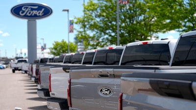 A line of unsold 2024 F150 pickup trucks sit at a Ford dealership Sunday, May 19, 2024, in Denver.