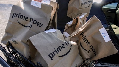 Amazon Prime Now bags loaded for delivery outside a Whole Foods store, Cincinnati, Feb. 8, 2018.