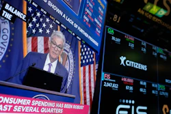 A screen displays a news conference with Federal Reserve Chairman Jerome Powell on the floor of the New York Stock Exchange, May 1, 2024.