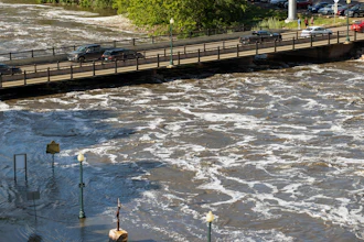 Water flows dangerously under the Falls Park Drive bridge at Falls Park, Sioux Falls, S.D., June 22, 2024.