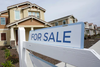 A for sale sign posted in front of a home in Sacramento, Calif., March 3, 2022.