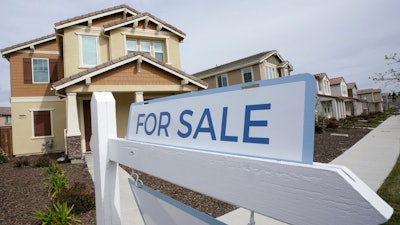 A for sale sign posted in front of a home in Sacramento, Calif., March 3, 2022.