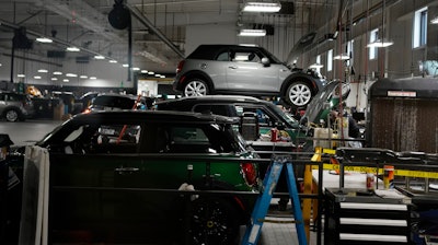 Cooper models in the service bay of a Mini dealership, Highlands Ranch, Colo., Nov. 3, 2022.
