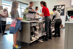 Workers serve customers at a fast food restaurant in Denver, June 27, 2024.