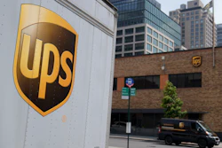 A delivery vehicle passes by a UPS depot, New York, June 29, 2023.