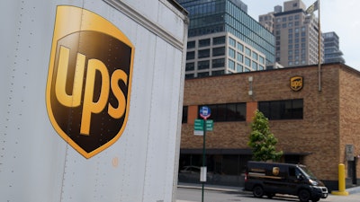 A delivery vehicle passes by a UPS depot, New York, June 29, 2023.