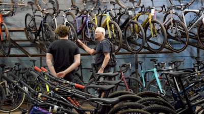 Customer Dan Inks, right, shops at University Bicycles in Boulder, Colo.