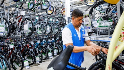 A worker organizes bicycles at a Walmart Superstore, Secaucus, N.J., July 11, 2024.