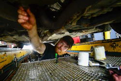 Ian Frank, a pit technician at Stop & Go on Putney Road in Brattleboro, Vt., changes the oil on a vehicle, July 15, 2024.