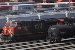 Employees are seen on a locomotive being moved at the Canadian Pacific Kansas City (CPKC) rail yard in Port Coquitlam, British Columbia, Monday, Aug. 19, 2024.