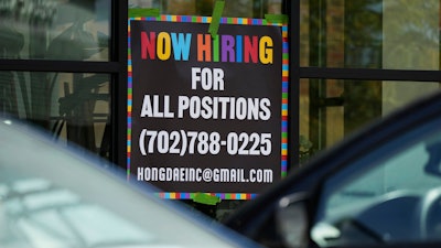 A hiring sign is displayed at a restaurant in Mount Prospect, Ill., Tuesday, Aug. 27, 2024.