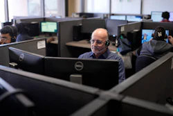 Stanley Solis, center, and other representatives take calls at an Alorica center in San Antonio, Aug. 19, 2024.