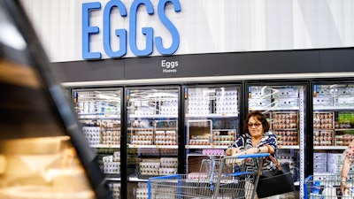 A woman buys eggs at a Walmart Superstore in Secaucus, New Jersey, July 11, 2024.