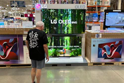 A shopper examines large-screen televisions in a Costco warehouse, Lone Tree, Colo., Sept. 19, 2024.