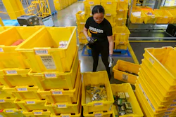 An employee scans incoming items at the Amazon OXR1 fulfillment center, Oxnard, Calif., Aug. 21, 2024.