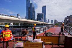Workers refurbish an overhead pedestrian bridge, Shanghai, Oct. 9, 2024.