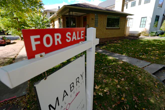 A sale sign stands outside a home in the east Washington Park neighborhood of Denver, Oct. 17, 2024.