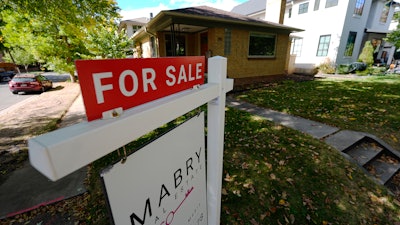 A sale sign stands outside a home in the east Washington Park neighborhood of Denver, Oct. 17, 2024.