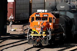 A worker boards a locomotive at a BNSF rail yard, Sept. 14, 2022, Kansas City, Kan.