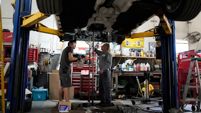 Auto mechanics at Express Auto Service Inc., Chicago, Sept. 19, 2024.