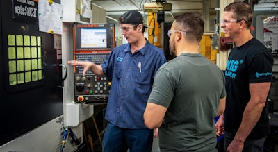 Jason Zenger and Nick Goellner speak with a machinist about his CNC machining processes.