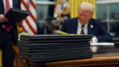 President Trump signs executive orders in the Oval Office of the White House, Jan. 20, 2025.