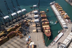 Cranes load and unload containers from cargo ships at the Cristobal port, operated by the Panama Ports Company, in Colon, Panama, Tuesday, Feb. 4, 2025.