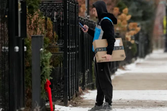 An Amazon delivery man delivers a package, Chicago, Jan. 8, 2025.