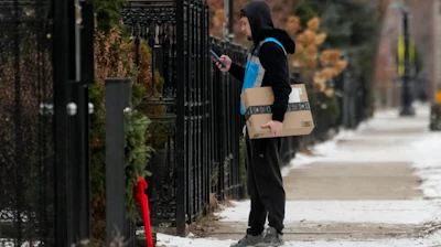 An Amazon delivery man delivers a package, Chicago, Jan. 8, 2025.