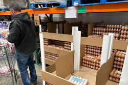 A consumer places eggs in a shopping cart in a Costco warehouse, Feb. 18, 2025, Sheridan, Colo.