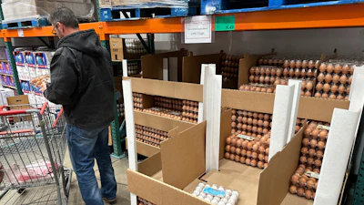 A consumer places eggs in a shopping cart in a Costco warehouse, Feb. 18, 2025, Sheridan, Colo.