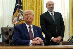 President Donald Trump listens to a question from a reporter as Commerce Secretary nominee Howard Lutnick watches after Trump signed an executive order in the Oval Office of the White House, Thursday, Feb. 13, 2025, in Washington.