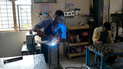 A worker welds a steel chassis at a factory in a suburb of Bengaluru, India, Thursday, Feb. 27, 2025.